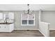 Dining area with modern chandelier, window views, and hardwood flooring at 2478 Verbena Nw Cir, Atlanta, GA 30314