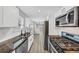 Modern kitchen features stainless steel appliances, dark countertops and white cabinetry at 2478 Verbena Nw Cir, Atlanta, GA 30314