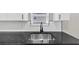 Close up of kitchen counter with stainless steel sink and sleek black faucet at 2478 Verbena Nw Cir, Atlanta, GA 30314