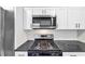 Kitchen with stainless steel microwave, gas stove, and granite countertops at 2478 Verbena Nw Cir, Atlanta, GA 30314