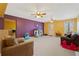Finished basement area with couches, play structures and multi-colored walls at 2845 Englewood Dr, Cumming, GA 30040