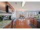 Open-concept kitchen with stainless steel appliances, granite countertops, and a seamless flow to the dining area at 2845 Englewood Dr, Cumming, GA 30040