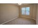 Cozy bedroom with neutral carpet and a window for natural light at 4858 Westridge Dr, Norcross, GA 30093