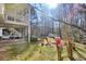 Landscaped backyard featuring a fire pit, shed, and outdoor seating at 684 Oak Moss Dr, Lawrenceville, GA 30043