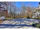 Spacious backyard with a shed, stairs leading to the upper-level porch, and trees at 684 Oak Moss Dr, Lawrenceville, GA 30043