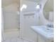 All-white bathroom featuring a classic pedestal sink and shower at 684 Oak Moss Dr, Lawrenceville, GA 30043
