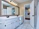 This bright bathroom features a double sink vanity, updated fixtures, and a tiled floor at 684 Oak Moss Dr, Lawrenceville, GA 30043
