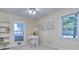 Serene bedroom with two windows and a cozy reading nook and desk at 684 Oak Moss Dr, Lawrenceville, GA 30043
