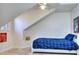 This cozy bedroom has a blue patterned comforter, a white frame bed, and a unique slanted wall at 684 Oak Moss Dr, Lawrenceville, GA 30043