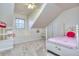 This charming bedroom has a pink flowered comforter, a white frame bed, and a built-in bookshelf at 684 Oak Moss Dr, Lawrenceville, GA 30043