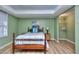 Inviting bedroom featuring wood floors and soothing green walls at 684 Oak Moss Dr, Lawrenceville, GA 30043