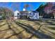 A view of the back exterior with an upper-level porch and a spacious yard at 684 Oak Moss Dr, Lawrenceville, GA 30043