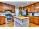 Charming kitchen featuring a center island and stainless steel appliances at 684 Oak Moss Dr, Lawrenceville, GA 30043