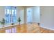 Bright living room with hardwood floors, large window and front door at 684 Oak Moss Dr, Lawrenceville, GA 30043