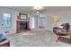 Spacious living room with a red brick fireplace, neutral carpet, a ceiling fan, and a cozy recliner at 684 Oak Moss Dr, Lawrenceville, GA 30043