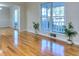 Spacious room with large windows showcases gleaming hardwood floors and neutral decor at 684 Oak Moss Dr, Lawrenceville, GA 30043