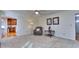 Open living room with a ceiling fan, neutral carpet, and easy access to the kitchen and front entry at 684 Oak Moss Dr, Lawrenceville, GA 30043