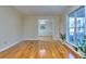 The bright, spacious living room features gleaming hardwood floors and large windows at 684 Oak Moss Dr, Lawrenceville, GA 30043