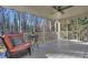 Relaxing screened porch with furniture, ceiling fan, and wood flooring at 684 Oak Moss Dr, Lawrenceville, GA 30043