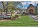 A large green backyard features an outdoor pavilion with a stone fireplace and a decorative truck sculpture at 2620 Middle Coray Cir, Marietta, GA 30066