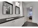 This bathroom includes a double sink vanity, granite countertops, white cabinetry, and sleek tile flooring at 2620 Middle Coray Cir, Marietta, GA 30066