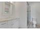 This bathroom features a glass shower, toilet, white vanity with a stone countertop, and a modern mirror at 2620 Middle Coray Cir, Marietta, GA 30066