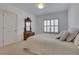 This bedroom features a bright interior, a bed with many pillows, and a beautiful wooden dresser with mirror at 2620 Middle Coray Cir, Marietta, GA 30066