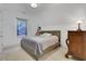 Bedroom features a classic lamp, a surfboard decor piece, a window, and neutral walls at 2620 Middle Coray Cir, Marietta, GA 30066