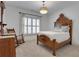 Bedroom features a wooden bed frame, shuttered windows, rocking chair, and vintage nightstand at 2620 Middle Coray Cir, Marietta, GA 30066