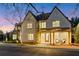 A luxury traditional home with a light colored brick exterior, dark roof, and welcoming front porch at 2620 Middle Coray Cir, Marietta, GA 30066
