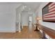 Bright hallway featuring hardwood floors, recessed lighting, and a vintage console table and flag artwork at 2620 Middle Coray Cir, Marietta, GA 30066