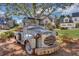 A decorative antique truck lawn ornament is surrounded by lush landscaping and mature trees at 2620 Middle Coray Cir, Marietta, GA 30066