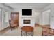 Cozy living room featuring a fireplace, a mounted television, and hardwood flooring at 2620 Middle Coray Cir, Marietta, GA 30066