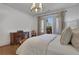 Cozy main bedroom with neutral tones, a decorative chandelier and plantation shutters at 2620 Middle Coray Cir, Marietta, GA 30066