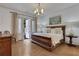 Bright main bedroom features hardwood floors, a chandelier, and doors to the outside at 2620 Middle Coray Cir, Marietta, GA 30066