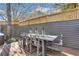 Outdoor dining area features a long table and chairs, perfect for gatherings on the wooden patio at 2620 Middle Coray Cir, Marietta, GA 30066