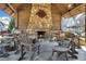 A stone fireplace is the focal point of the outdoor pavilion, which features timber beams and comfortable seating at 2620 Middle Coray Cir, Marietta, GA 30066