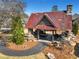 An aerial view of a stone and timber outdoor pavilion with seating and a stone fireplace and a rusted metal roof at 2620 Middle Coray Cir, Marietta, GA 30066