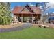 A stone and timber outdoor pavilion with stone columns and a metal roof, framed by a curved walkway and landscaping at 2620 Middle Coray Cir, Marietta, GA 30066