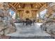 A view from inside the outdoor pavilion, which features a stone fireplace, timber beams, and an outdoor dining set at 2620 Middle Coray Cir, Marietta, GA 30066
