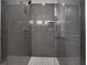 This shower includes gray tile, a rain shower head, a glass enclosure, and a built in shelf at 2620 Middle Coray Cir, Marietta, GA 30066