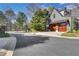 Street view of a house in a quiet suburban neighborhood featuring private road access and wooden garage doors at 2620 Middle Coray Cir, Marietta, GA 30066