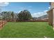 Expansive fenced backyard with lush green lawn, perfect for outdoor activities and relaxation at 3400 Palmer Lake Pointe, Douglasville, GA 30135