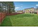 Picturesque backyard with a pristine lawn and secure wooden fence, ensuring privacy and charm at 3400 Palmer Lake Pointe, Douglasville, GA 30135