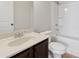 Bright bathroom featuring a single sink vanity, toilet, and tub with white tile surround at 3400 Palmer Lake Pointe, Douglasville, GA 30135