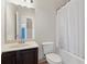 A compact bathroom features a single sink vanity, toilet, and a tub with a white shower curtain at 3400 Palmer Lake Pointe, Douglasville, GA 30135