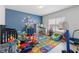 Bright bedroom with a crib, learning rug, a desk and lots of colorful toys at 3400 Palmer Lake Pointe, Douglasville, GA 30135