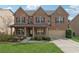 Beautiful brick home with manicured lawn, inviting front porch, and attached two-car garage, exuding curb appeal at 3400 Palmer Lake Pointe, Douglasville, GA 30135