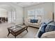 Inviting living room showcasing stylish furniture, natural light, and seamless transition to the dining area at 3400 Palmer Lake Pointe, Douglasville, GA 30135