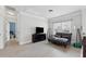 Comfortable living room with a black leather couch, flat screen TV, and bright light at 3400 Palmer Lake Pointe, Douglasville, GA 30135